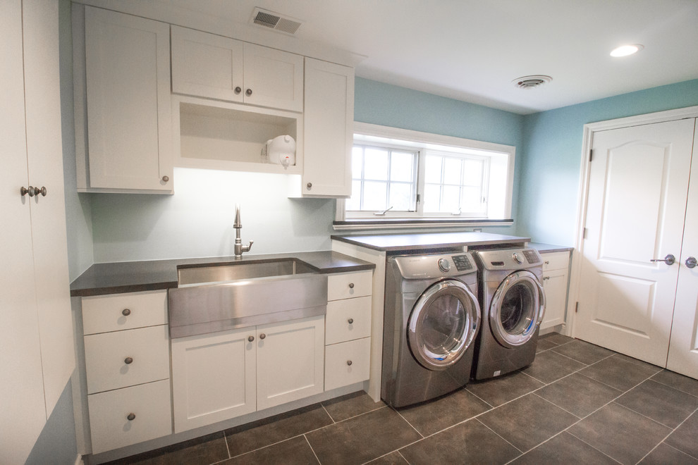 Mid-sized transitional single-wall dedicated laundry room in Detroit with a farmhouse sink, shaker cabinets, white cabinets, soapstone benchtops, blue walls, ceramic floors and a side-by-side washer and dryer.