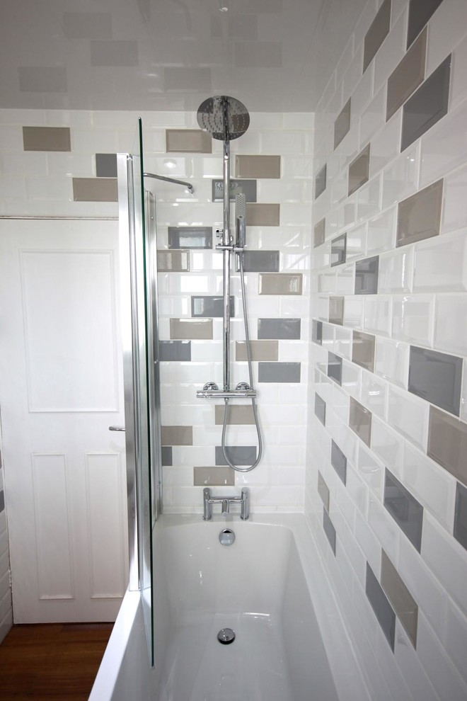 Example of a mid-sized trendy kids' multicolored tile and ceramic tile laminate floor and brown floor bathroom design in Other with furniture-like cabinets, white cabinets, a one-piece toilet, white walls and an integrated sink
