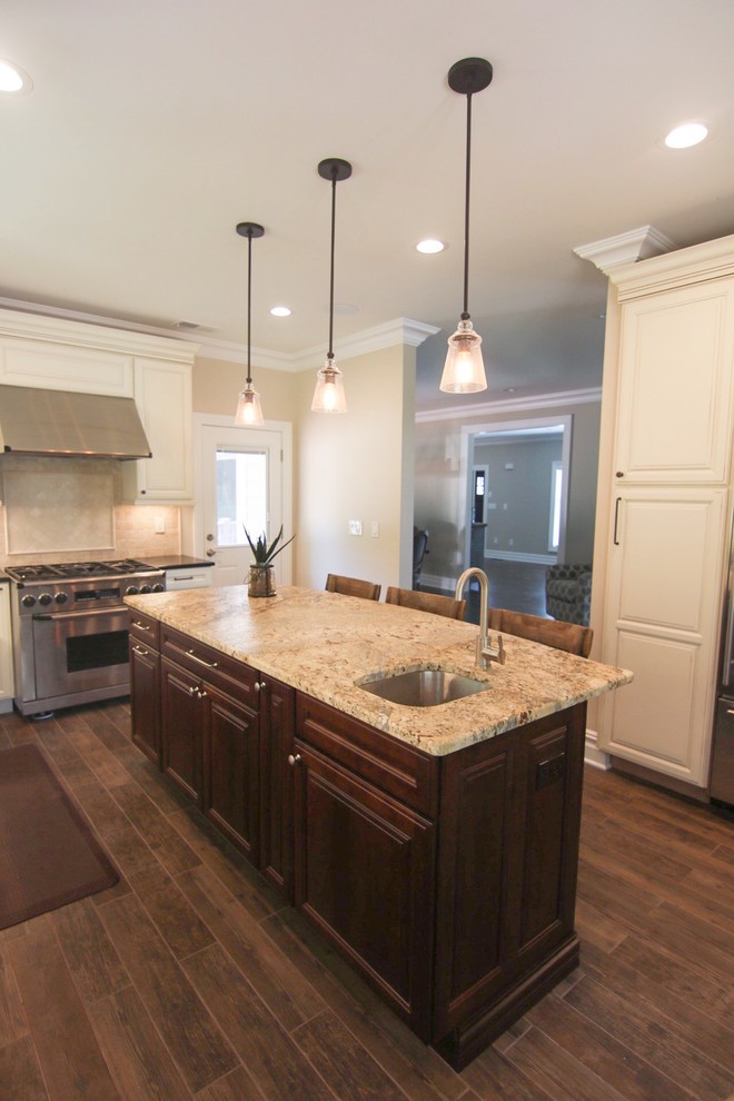 Mid-sized mountain style l-shaped dark wood floor and brown floor eat-in kitchen photo in New York with raised-panel cabinets, white cabinets, quartzite countertops, an island, beige countertops, an undermount sink, beige backsplash and stainless steel appliances