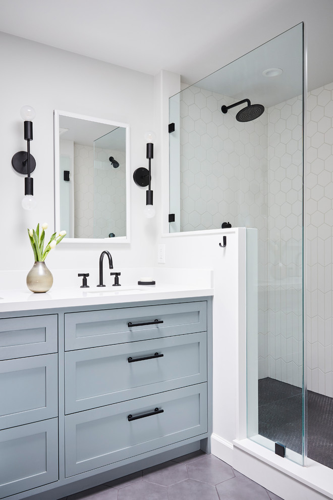 Inspiration for a transitional master bathroom in San Francisco with shaker cabinets, blue cabinets, a double shower, white tile, ceramic tile, white walls, ceramic floors, an undermount sink, engineered quartz benchtops, grey floor, a hinged shower door and white benchtops.