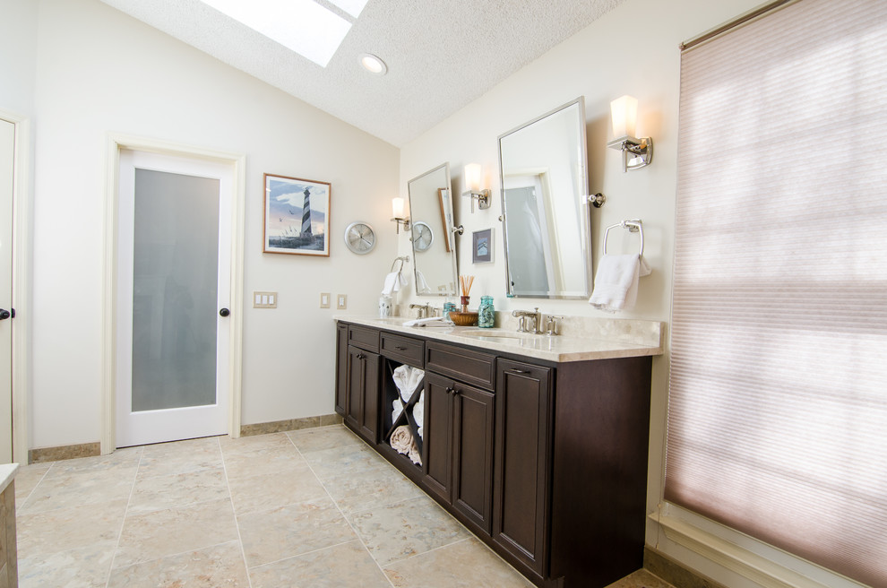 This is an example of a mid-sized eclectic bathroom in DC Metro with an undermount sink, recessed-panel cabinets, dark wood cabinets, engineered quartz benchtops, a drop-in tub, a corner shower, a two-piece toilet, multi-coloured tile, porcelain tile, white walls and porcelain floors.