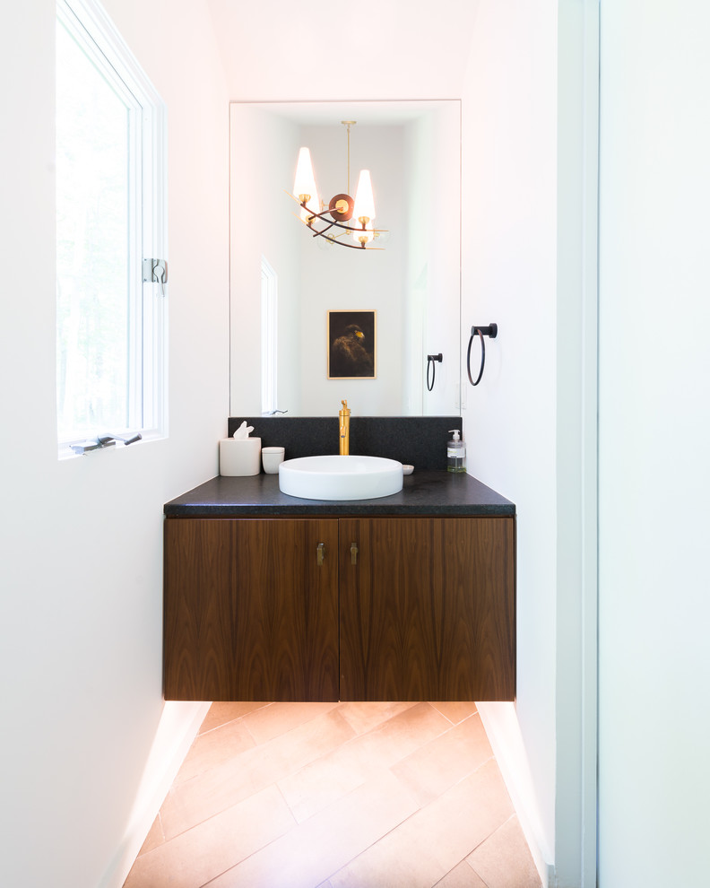 Design ideas for a mid-sized contemporary powder room in Bridgeport with flat-panel cabinets, dark wood cabinets, white walls, ceramic floors, a vessel sink and solid surface benchtops.