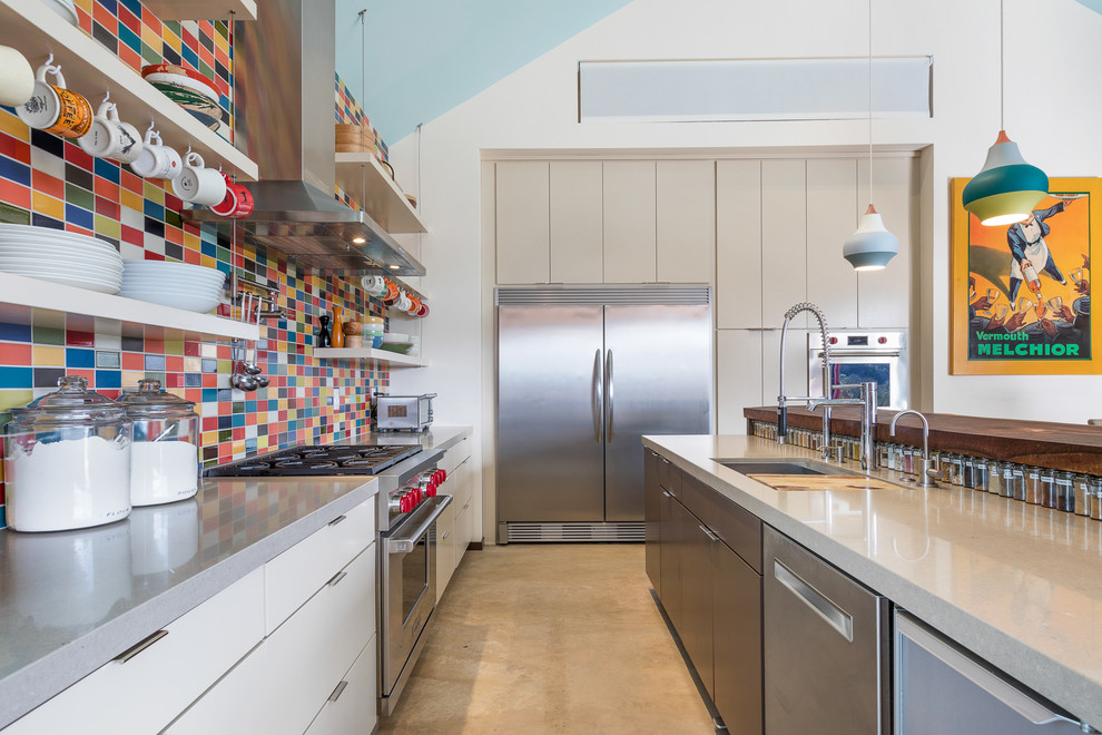 Inspiration for a mid-sized contemporary l-shaped eat-in kitchen in San Francisco with an undermount sink, flat-panel cabinets, beige cabinets, quartz benchtops, ceramic splashback, stainless steel appliances, concrete floors, with island and multi-coloured splashback.