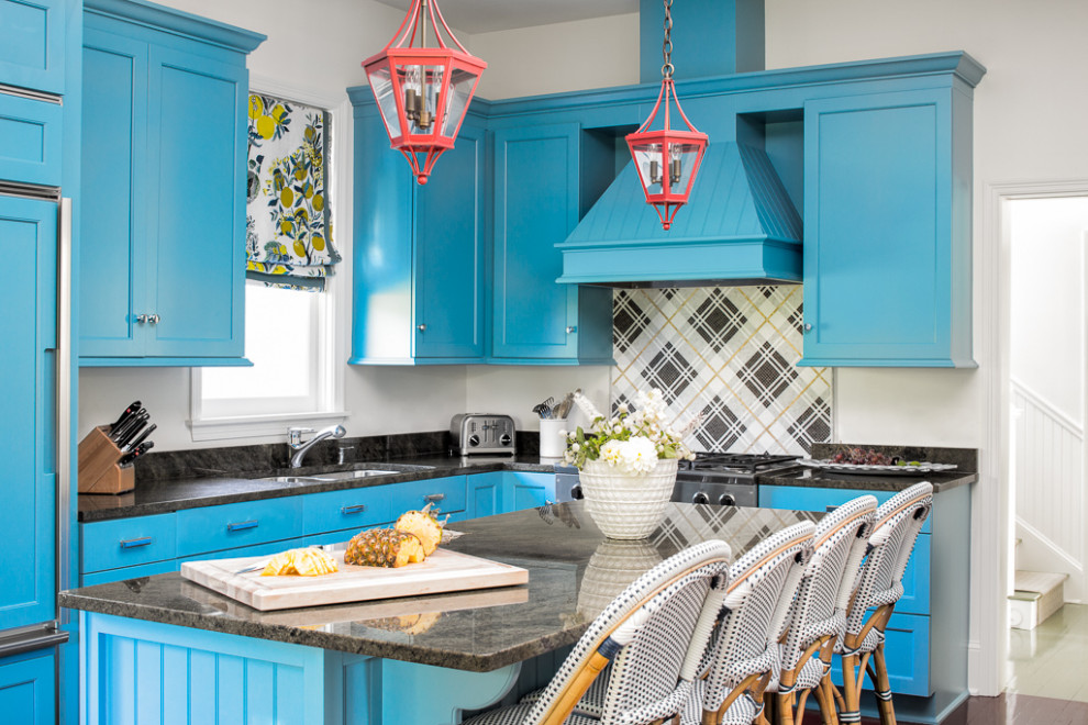 Inspiration for a beach style l-shaped kitchen in Portland Maine with an undermount sink, shaker cabinets, blue cabinets, multi-coloured splashback, stainless steel appliances, with island and black benchtop.