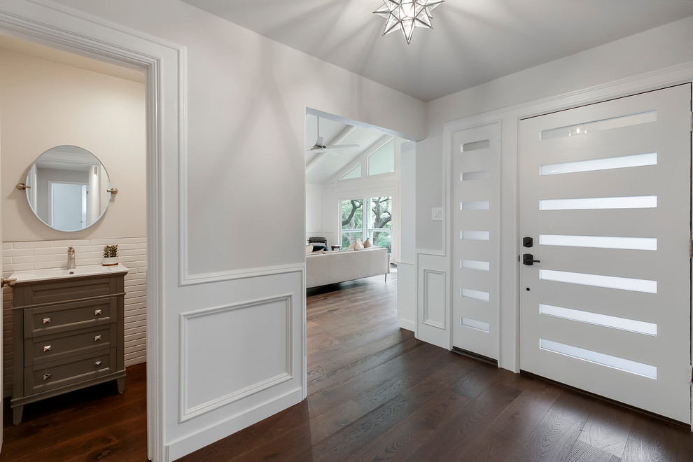 Foyer - mid-sized transitional dark wood floor and brown floor foyer idea in Austin with gray walls and a white front door