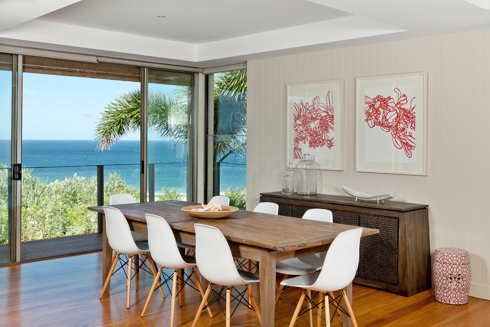 Photo of a contemporary dining room in Brisbane with medium hardwood floors and beige walls.