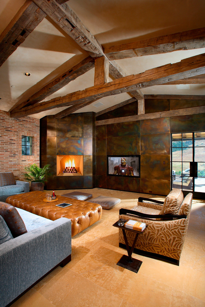 Photo of a mediterranean open concept family room in Orange County with a corner fireplace, a metal fireplace surround and a built-in media wall.
