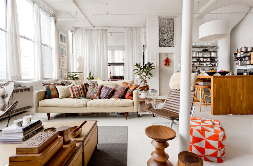Photo of an eclectic open concept living room in New York with white walls.