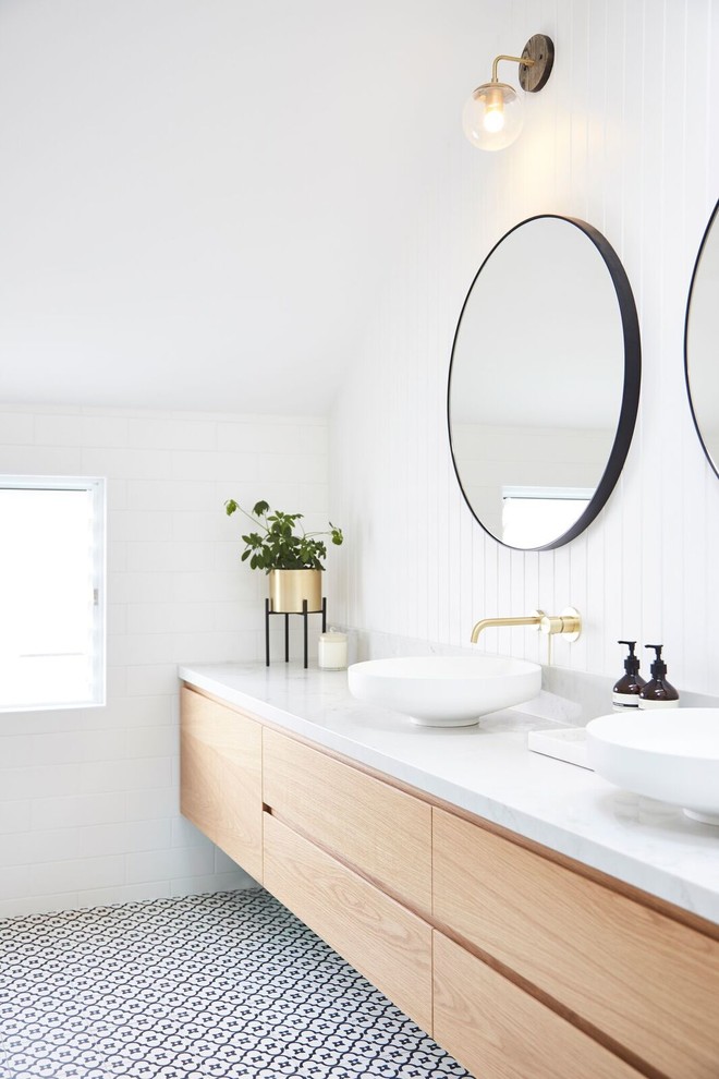 Contemporary master bathroom in Sydney with furniture-like cabinets, light wood cabinets, an open shower, a wall-mount toilet, white tile, ceramic tile, white walls, terra-cotta floors, a vessel sink, marble benchtops, multi-coloured floor and an open shower.