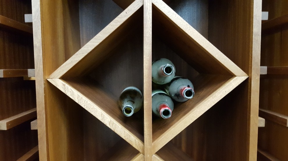 Mid-sized traditional wine cellar in Other with storage racks.