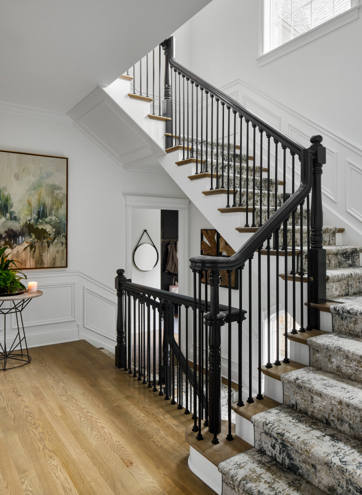 Inspiration for a classic wood u-shaped staircase in Chicago with painted wood risers and wainscoting.