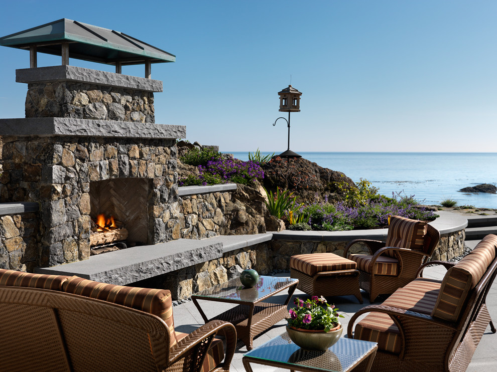 This is an example of a beach style patio in Vancouver with a fire feature.