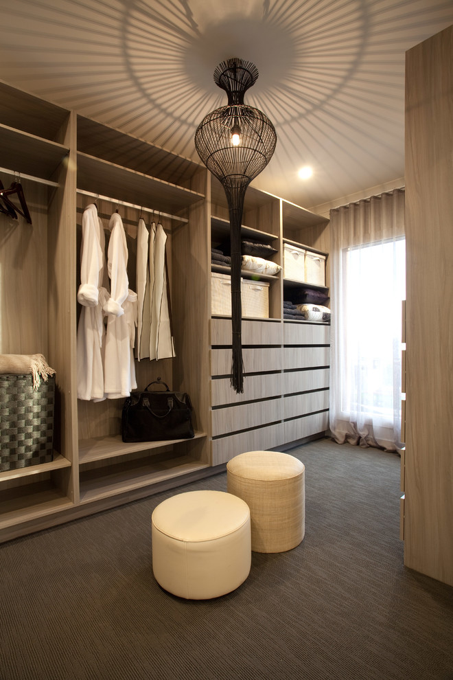 Inspiration for a mid-sized contemporary gender-neutral storage and wardrobe in Melbourne with flat-panel cabinets and carpet.