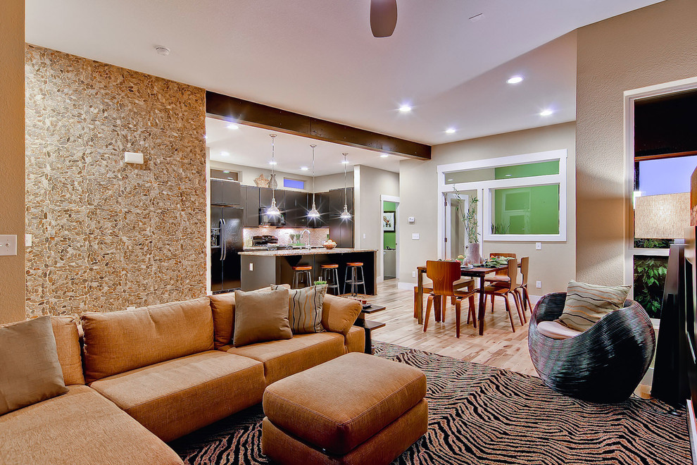 This is an example of a contemporary open concept living room in Denver with beige walls.