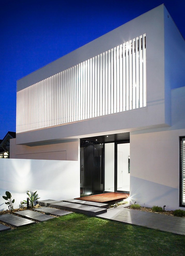 This is an example of a large contemporary two-storey white exterior in Melbourne with a flat roof.