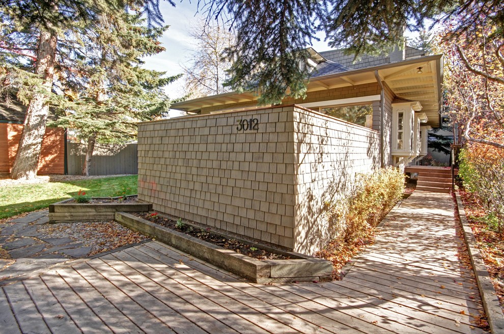 Example of a transitional exterior home design in Calgary