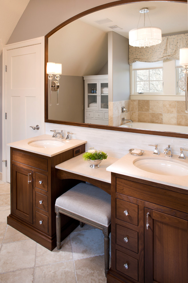 Design ideas for a traditional bathroom in Minneapolis with an undermount sink, dark wood cabinets and beige tile.