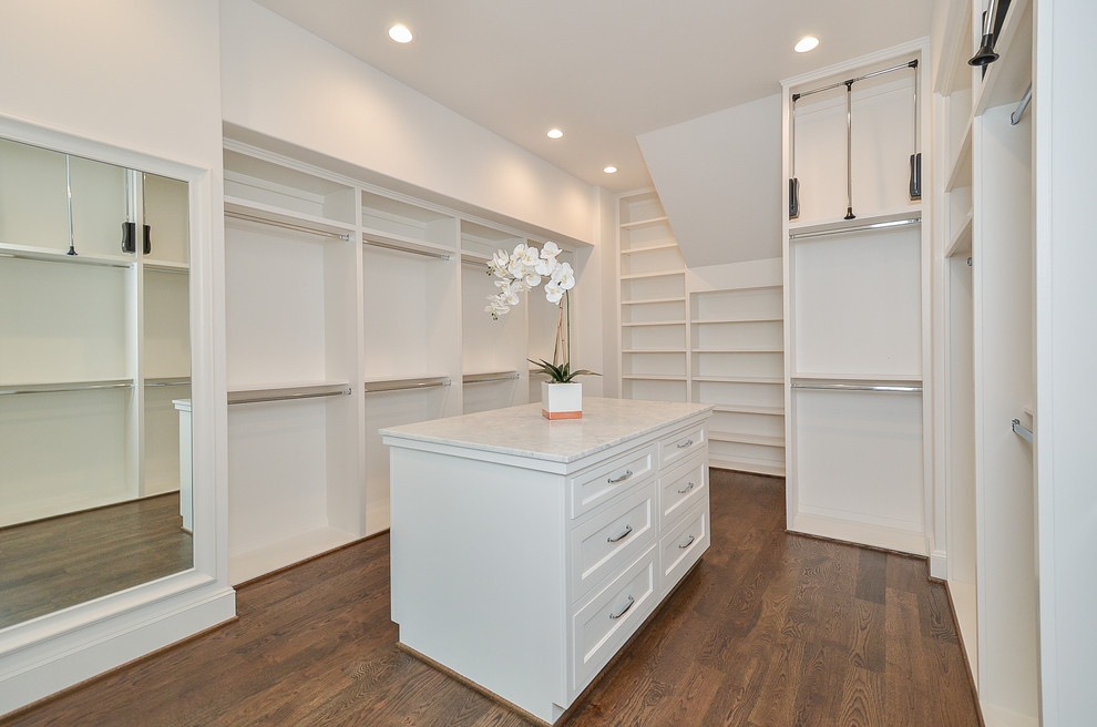 Inspiration for a mid-sized traditional gender-neutral walk-in wardrobe in Houston with open cabinets, white cabinets, medium hardwood floors and brown floor.