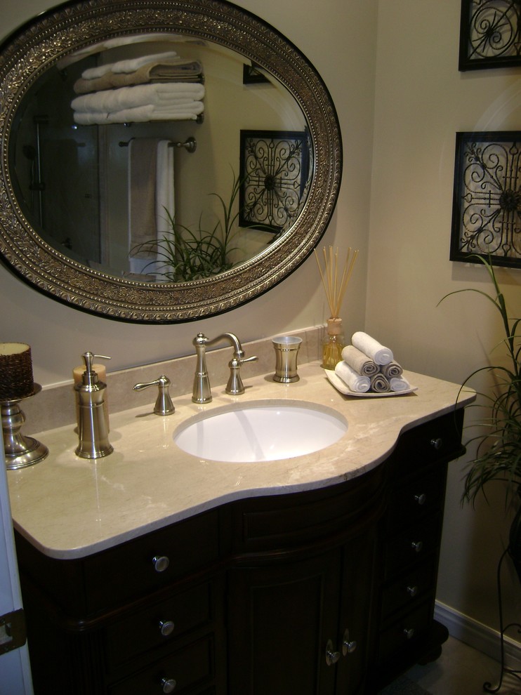 Design ideas for a small traditional bathroom in Los Angeles with an undermount sink, furniture-like cabinets, dark wood cabinets, engineered quartz benchtops, a shower/bathtub combo, a two-piece toilet, beige tile, ceramic tile, beige walls and porcelain floors.