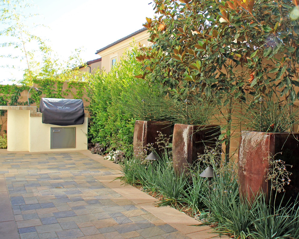 Design ideas for a mid-sized contemporary backyard patio in Orange County with no cover, an outdoor kitchen and tile.