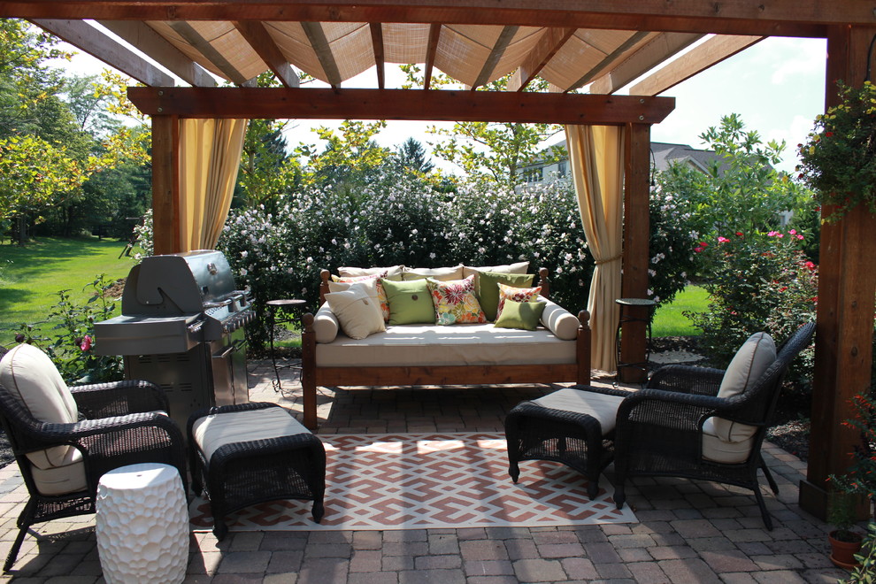 Inspiration for a mid-sized transitional backyard full sun formal garden for spring in Columbus with brick pavers.