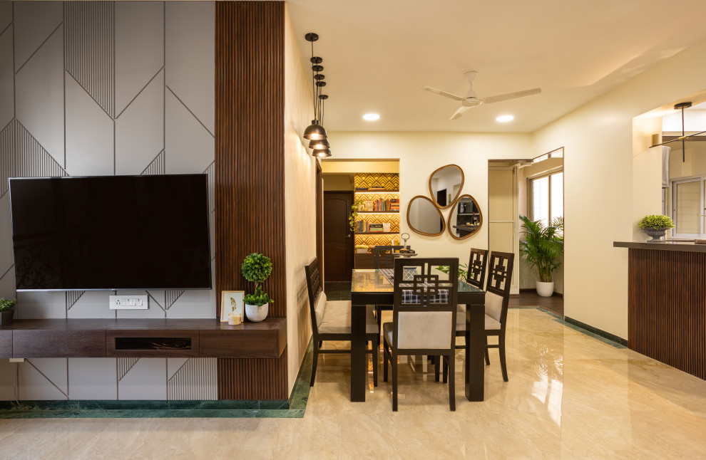 Design ideas for a large eclectic loft-style living room in Mumbai with a home bar, grey walls, terra-cotta floors and a built-in media wall.