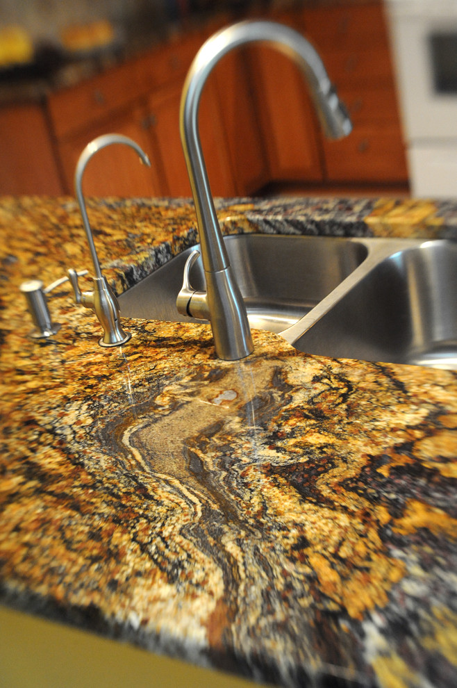 Mid-sized transitional u-shaped limestone floor and beige floor eat-in kitchen photo in Cincinnati with a double-bowl sink, shaker cabinets, medium tone wood cabinets, granite countertops, beige backsplash, ceramic backsplash, stainless steel appliances and a peninsula