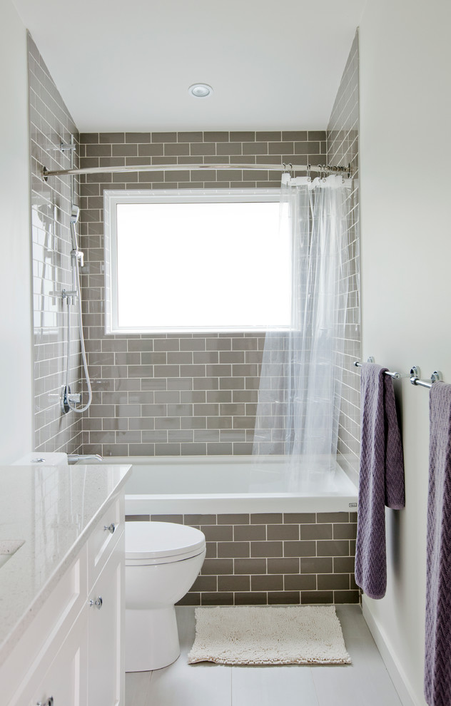 Mid-sized transitional 3/4 bathroom in Vancouver with recessed-panel cabinets, white cabinets, an alcove tub, a shower/bathtub combo, brown tile, subway tile, white walls, porcelain floors, an undermount sink, engineered quartz benchtops and a shower curtain.