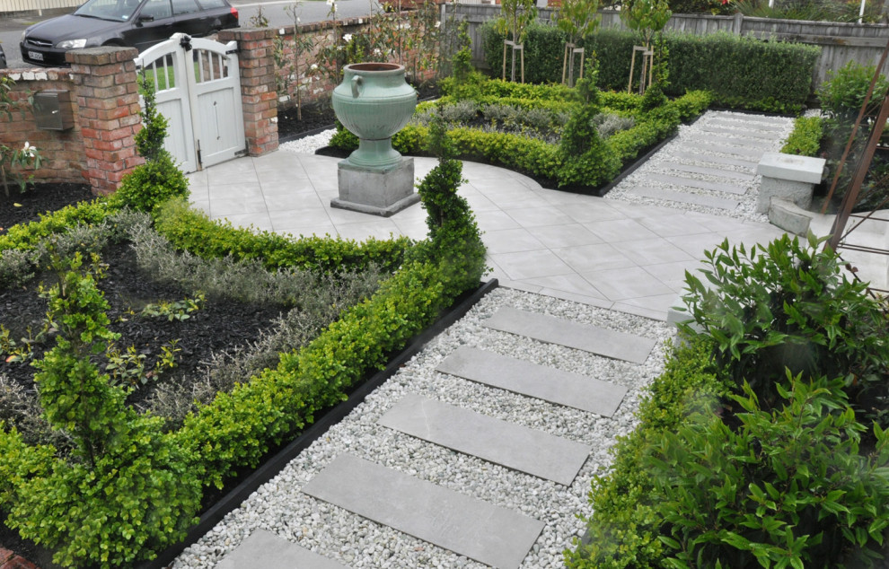 Inspiration for a small traditional front yard partial sun formal garden for spring in Wellington with a garden path and concrete pavers.