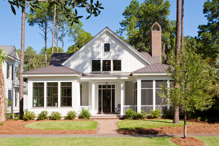 Mid-sized beach style two-storey white exterior in Charleston with concrete fiberboard siding.