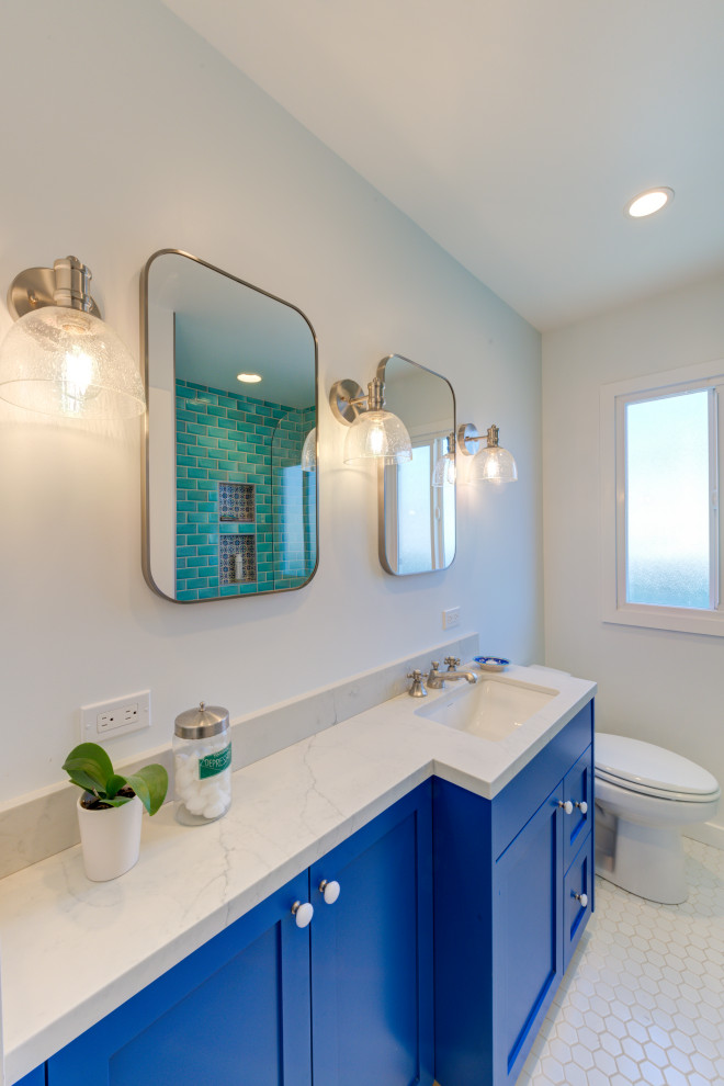 Inspiration for a mid-sized transitional bathroom in San Francisco with shaker cabinets, blue cabinets, an alcove tub, porcelain floors, an undermount sink, white floor, beige benchtops, a niche, a single vanity and a built-in vanity.