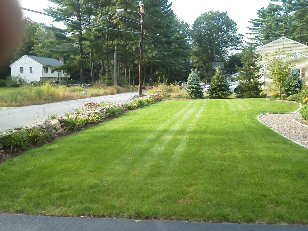 Photo of a mid-sized traditional front yard partial sun formal garden for spring in Boston with a garden path and gravel.