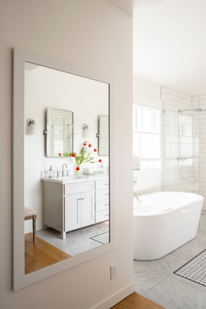 Large country master bathroom in San Francisco with shaker cabinets, white cabinets, a freestanding tub, an open shower, a one-piece toilet, white tile, subway tile, white walls, marble floors, a drop-in sink, marble benchtops, white floor, an open shower and white benchtops.