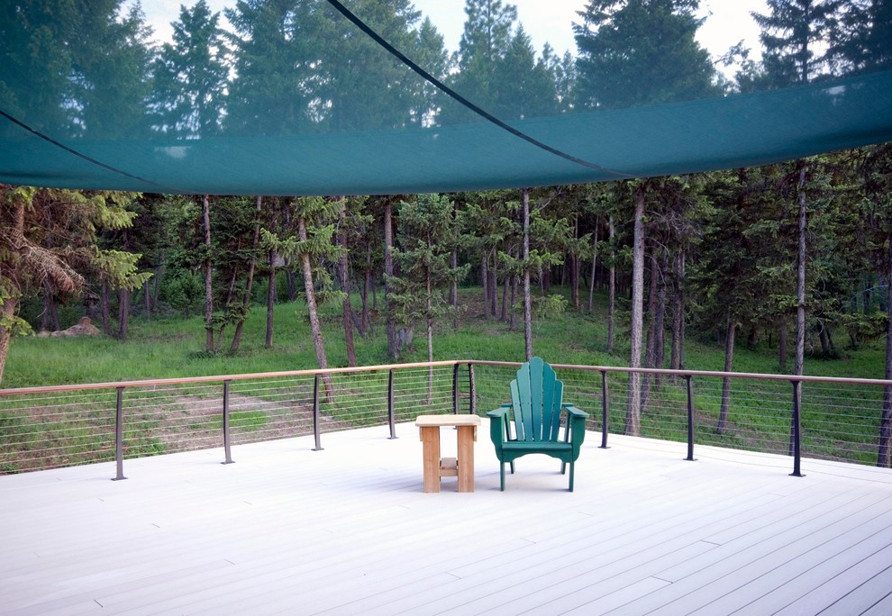 Mid-sized mountain style backyard deck photo in New York with an awning