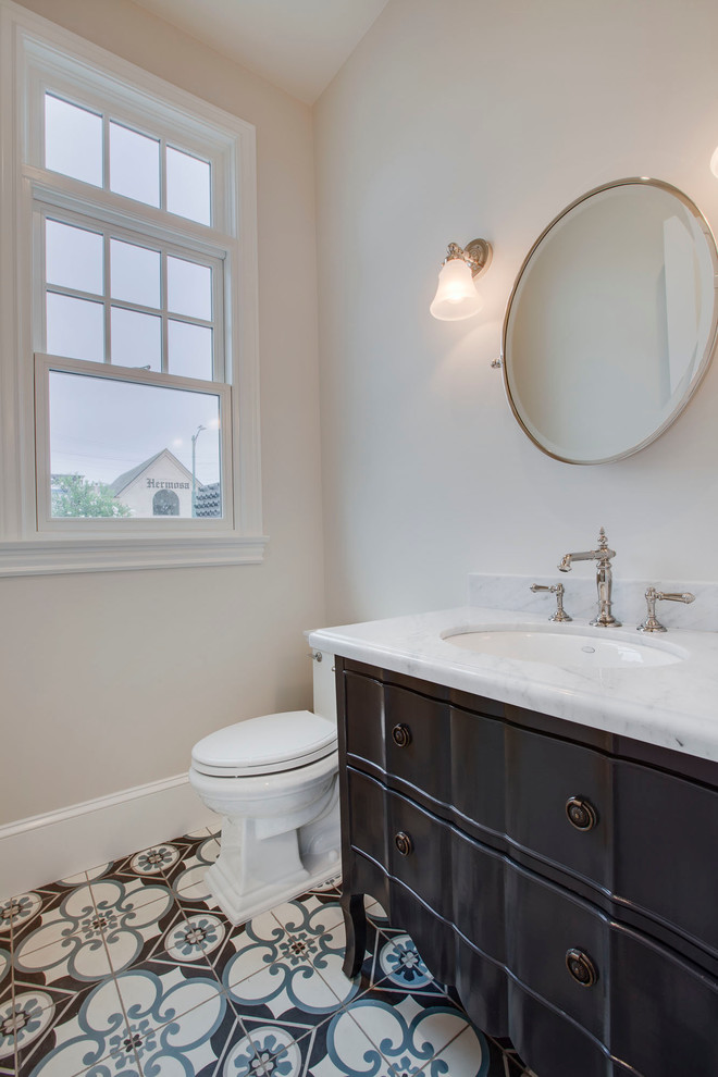 Traditional bathroom in San Diego with black cabinets, concrete floors, an undermount sink and marble benchtops.