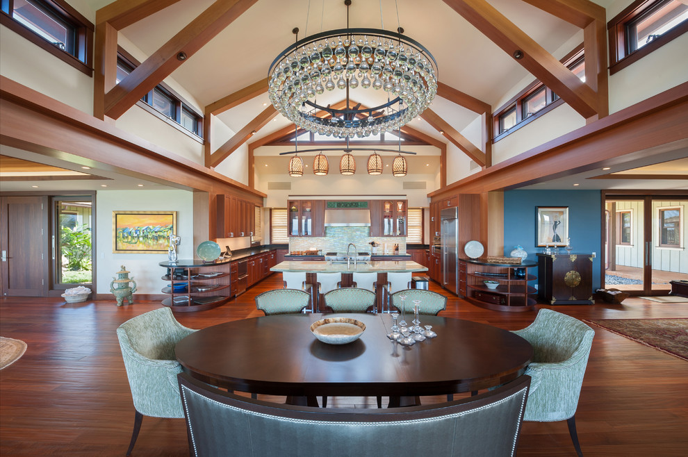 Photo of an expansive tropical open plan dining in Hawaii with white walls, medium hardwood floors and no fireplace.