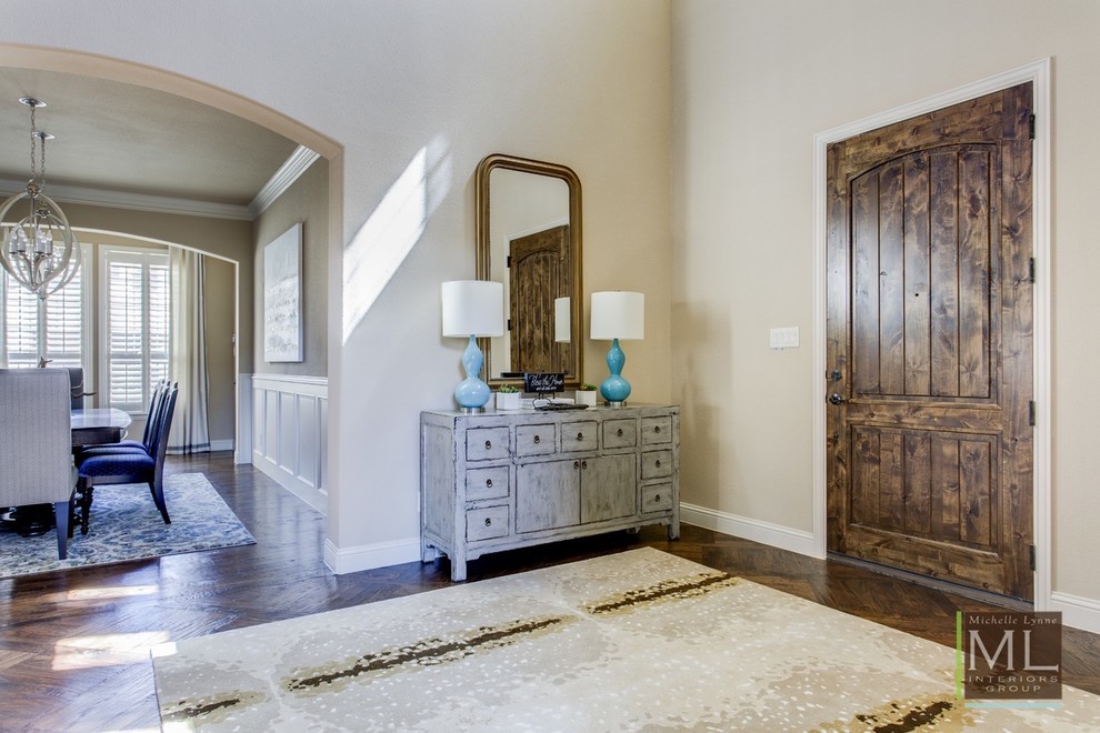 Design ideas for a large transitional foyer in Dallas with beige walls, medium hardwood floors, a single front door and a medium wood front door.