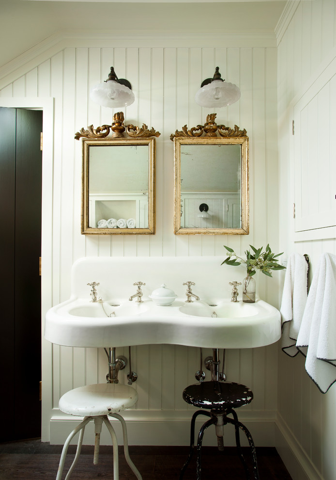 Inspiration for a country bathroom in Atlanta with white walls, dark hardwood floors, a wall-mount sink and brown floor.