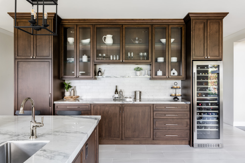 Example of a large transitional u-shaped porcelain tile and white floor open concept kitchen design in Vancouver with an undermount sink, recessed-panel cabinets, dark wood cabinets, quartz countertops, white backsplash, ceramic backsplash, stainless steel appliances, an island and white countertops