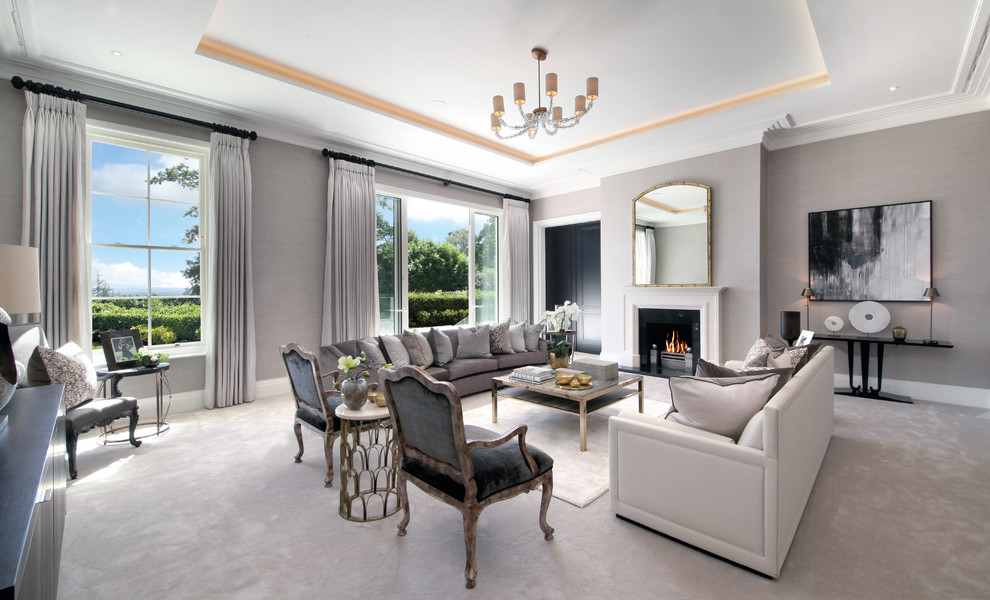 Photo of a transitional formal enclosed living room in Surrey with beige walls, carpet, a standard fireplace, a wood fireplace surround and no tv.