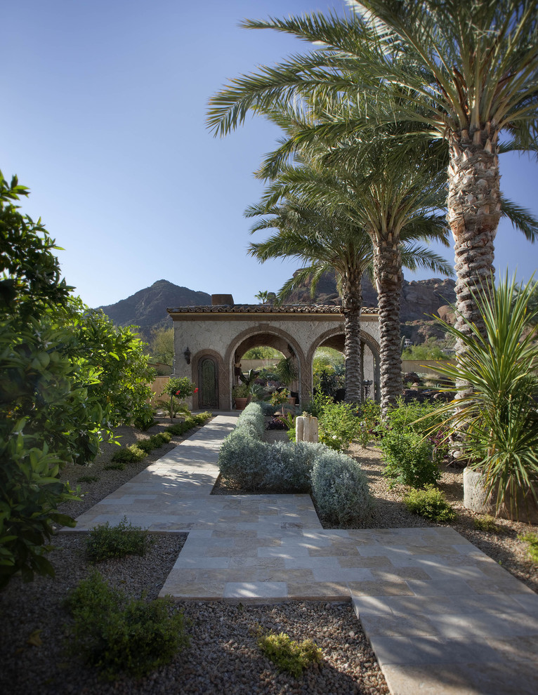 Photo of a mediterranean backyard garden in Phoenix with natural stone pavers.
