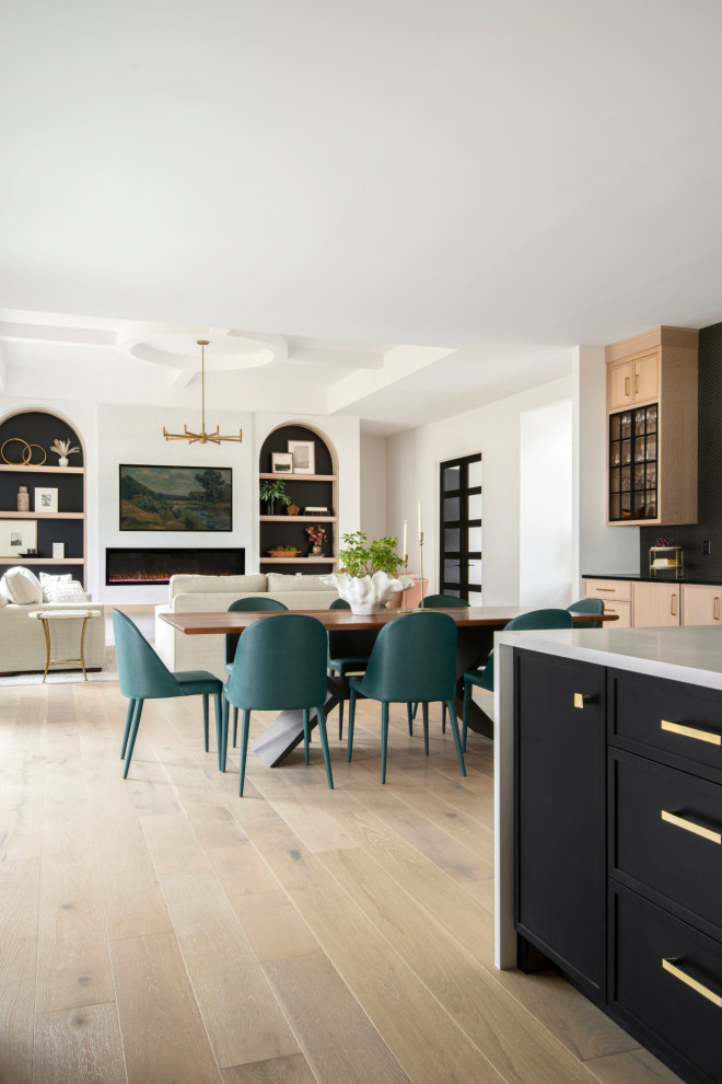 Example of a large transitional light wood floor, beige floor and coffered ceiling dining room design in St Louis with white walls and a ribbon fireplace