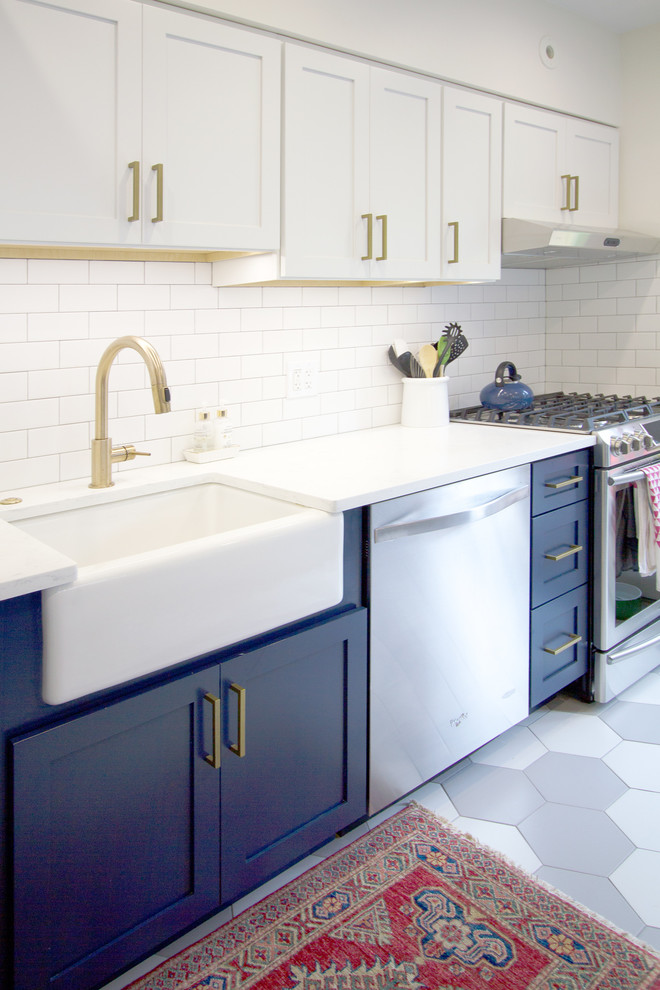 Inspiration for a mid-sized modern galley eat-in kitchen in Philadelphia with a farmhouse sink, recessed-panel cabinets, marble benchtops, white splashback, subway tile splashback, stainless steel appliances, porcelain floors, no island, multi-coloured floor, multi-coloured benchtop and blue cabinets.