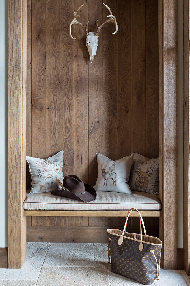 Inspiration for a country entryway in Dallas with brown walls and beige floor.