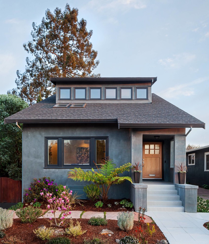 This is an example of a transitional one-storey grey house exterior in San Francisco with a gable roof and a shingle roof.