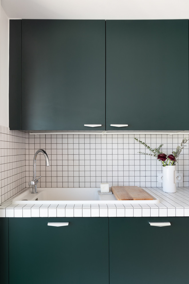 Example of a mid-sized trendy single-wall kitchen design in Paris with open cabinets, green cabinets, tile countertops, no island and white countertops