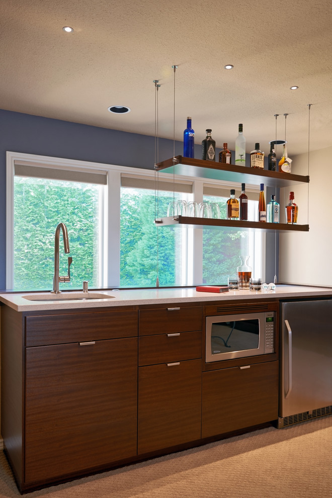 Contemporary wet bar in Portland with an undermount sink, flat-panel cabinets, medium wood cabinets, quartz benchtops and carpet.