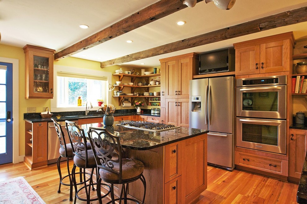 Open concept kitchen - mid-sized rustic l-shaped medium tone wood floor and brown floor open concept kitchen idea in Orange County with an undermount sink, shaker cabinets, medium tone wood cabinets, granite countertops, stainless steel appliances and an island