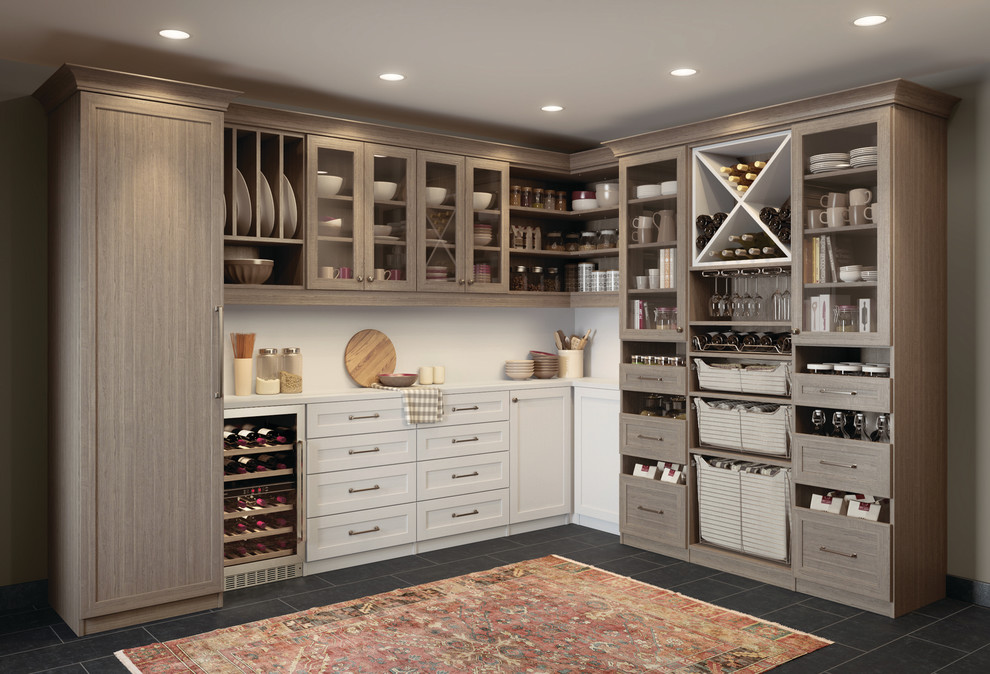 Inspiration for a large traditional l-shaped kitchen pantry in Nashville with glass-front cabinets, medium wood cabinets, granite benchtops, slate floors and no island.