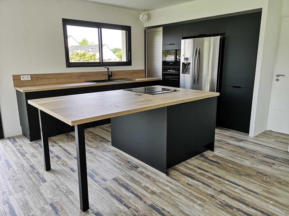 Photo of a mid-sized modern l-shaped eat-in kitchen in Other with an undermount sink, black cabinets, wood benchtops, timber splashback, black appliances, vinyl floors and with island.